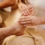 Close-up of a foot massage in a spa setting, highlighting relaxation and wellness.